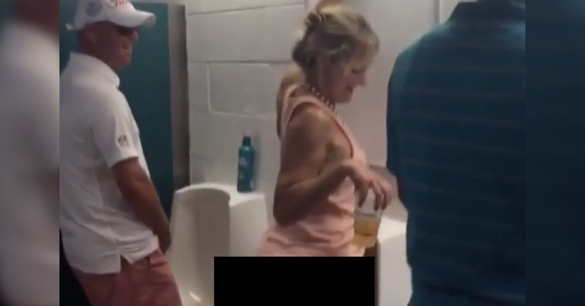 woman helping man pee
